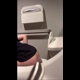 A hidden camera records an unsuspecting cutie from behind as she sits on a toilet in a public restroom and takes a shit. You can see her seated rear view throughout, and bathroom audio is audible. Vertical format video. About 2.5 minutes.